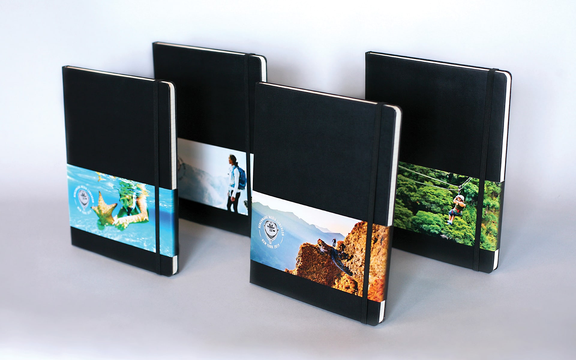 four notebooks with belly bands