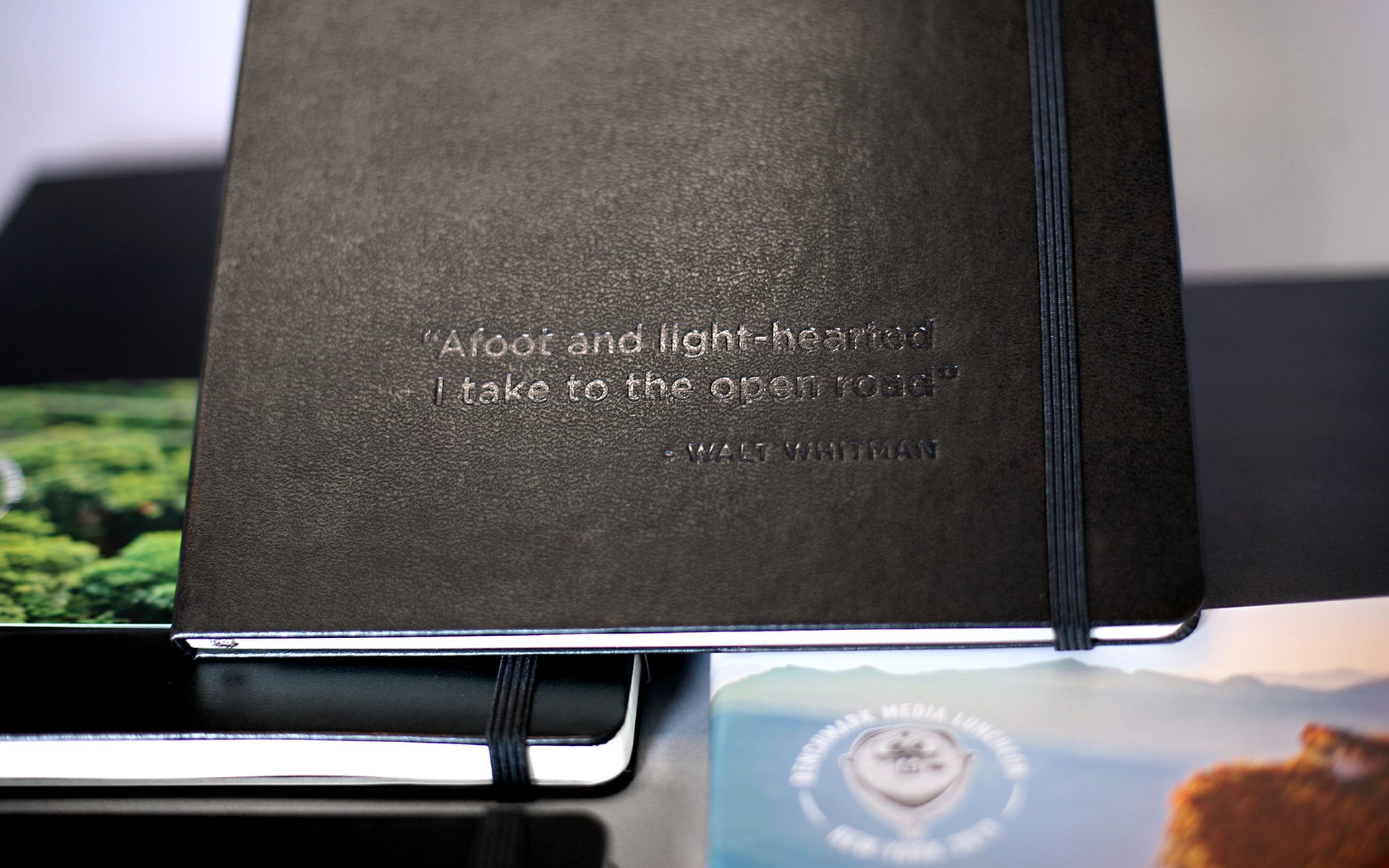 notebook with embossed Walt Whitman quote